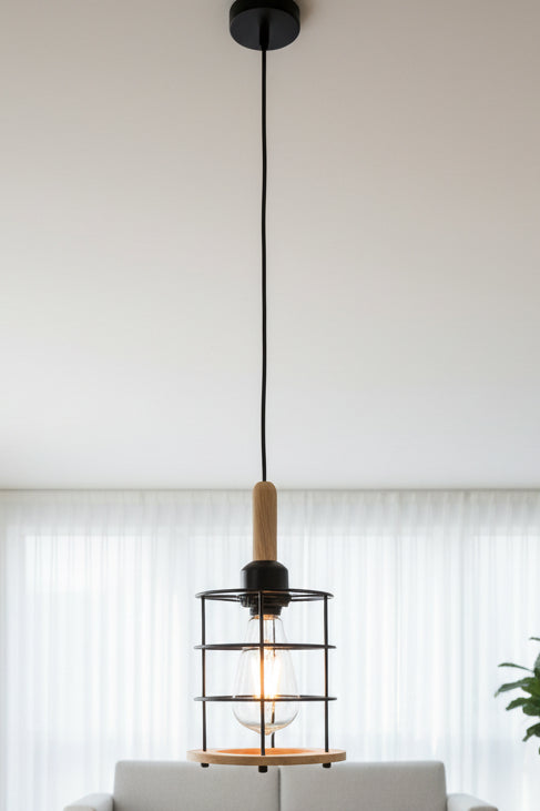 A pendant light with an edison-style bulb, metal cage, and wooden elements, hanging from the ceiling.