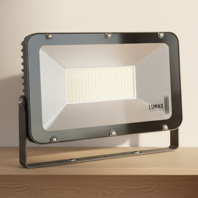 A sand grey LUMAX SMD LED 200W flood light with a rotatable feature, displayed against an indoor setting.