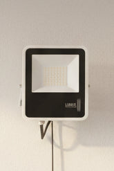 A white LUMAX brand LED flood light with a rotatable head, displaying the LED array on the front.