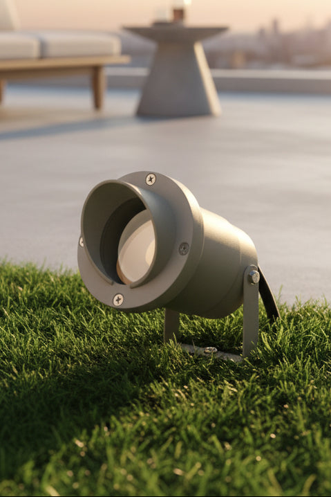 Gray outdoor spotlight on grass with blurred background