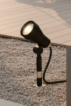 Black outdoor spotlight on grass