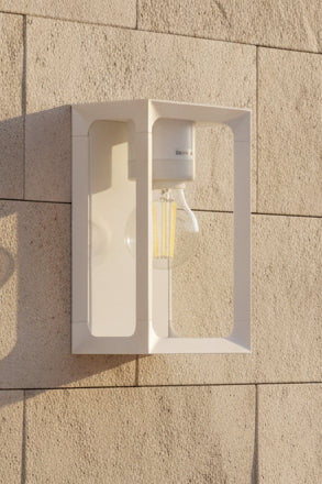 A white outdoor light fixture with a clear glass cover and a visible bulb inside, designed to mount E27 bulbs.